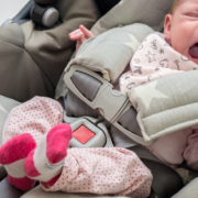 newborn baby girl in a car seat